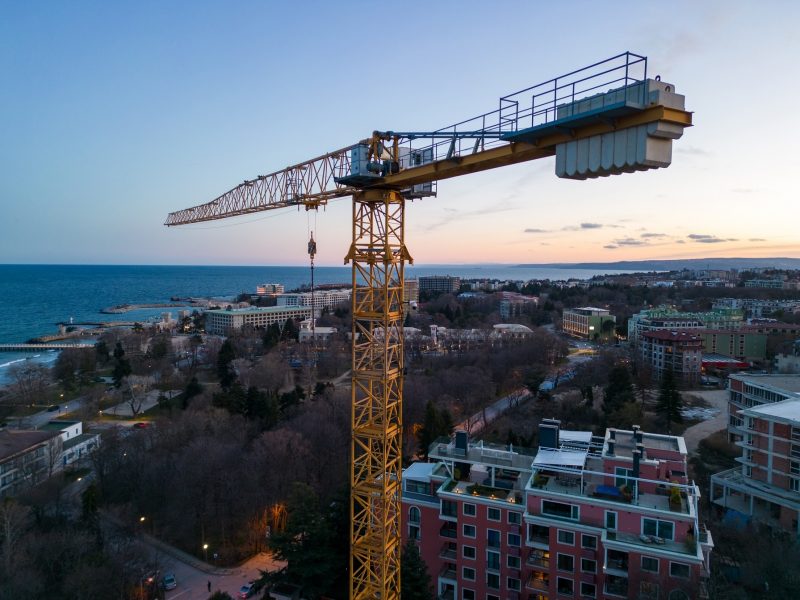 Busy Construction Site and Construction Equipment at night. Aerial top view